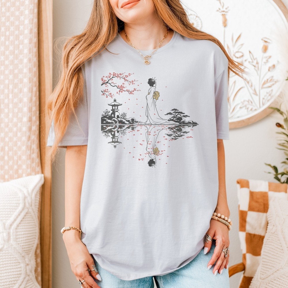 Woman Reflected in Still Water Among Falling Blossoms Tee